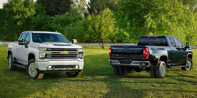 Black and white Chevrolet Silverado parked in a green field