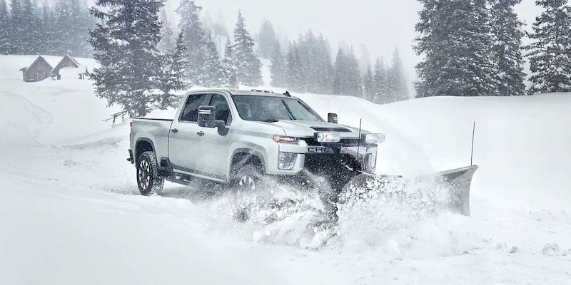 Chevrolet Silverado clearing snow with a snow plow attachment